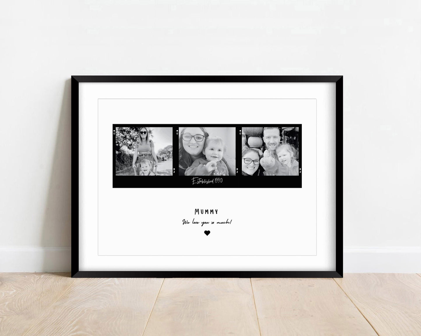 A framed black and white print featuring three candid mother-child photographs arranged in a film strip style. The center of the print includes the text "Established date." Below the images, Mum, Mummy, Mamma etc can be added. The frame can be black or white and the background is minimalistic.