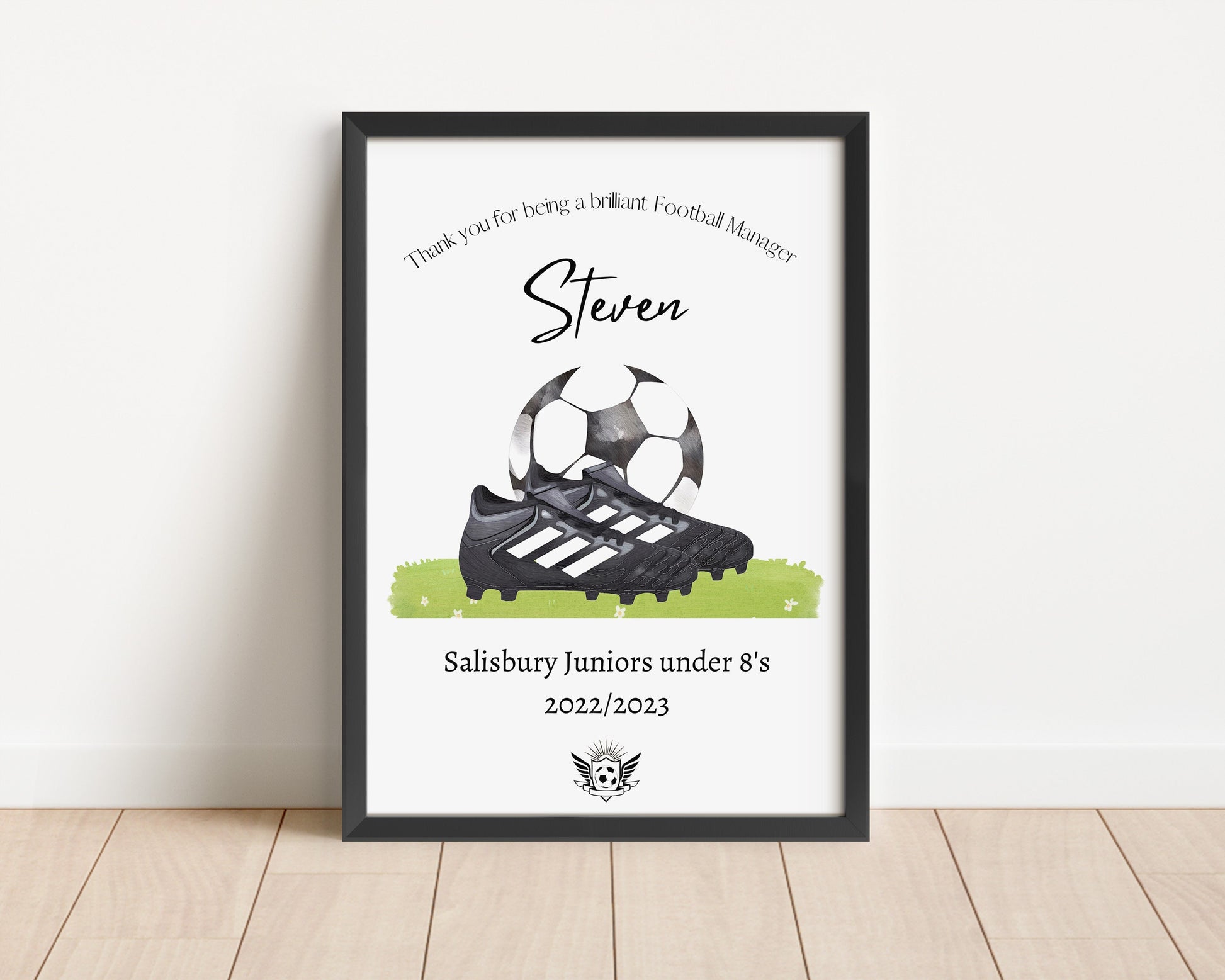 Personalised football print featuring the title ‘Coach’ or ‘Manager’ with the recipient’s name, team name, year, and team logo. The design includes a watercolour-style illustration of a football boot and ball, combining text and imagery in a sporty, artistic layout.