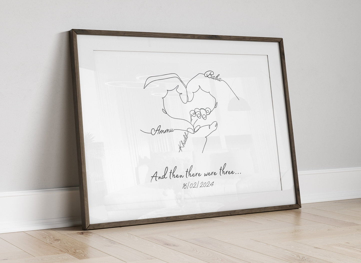 Newborn keepsake print displaying overlapping hands of parents and baby, customized with family details.