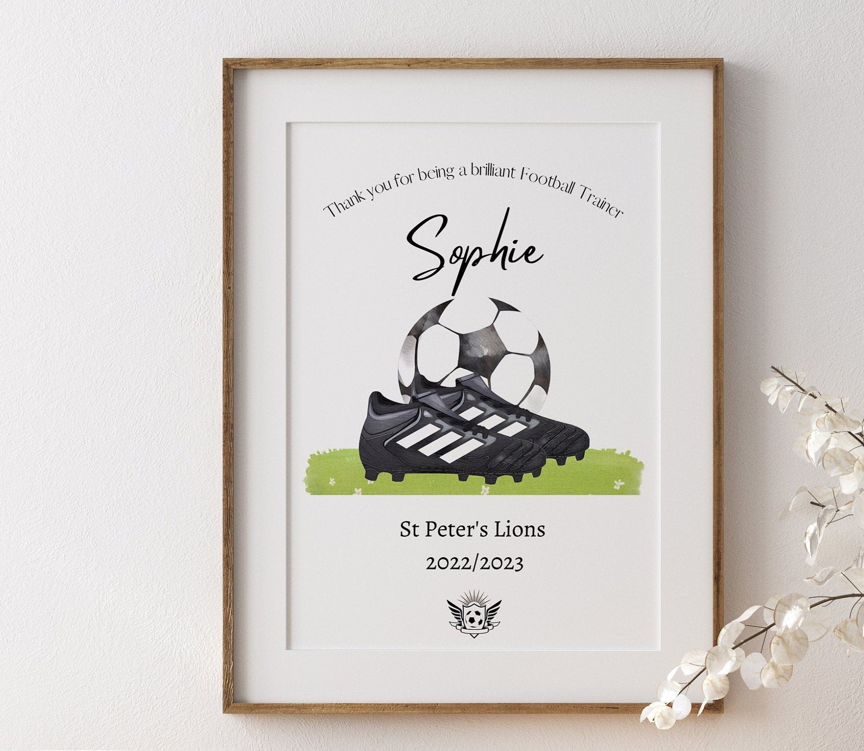 Personalised football print featuring the title ‘Coach’ or ‘Manager’ with the recipient’s name, team name, year, and team logo. The design includes a watercolour-style illustration of a football boot and ball, combining text and imagery in a sporty, artistic layout.