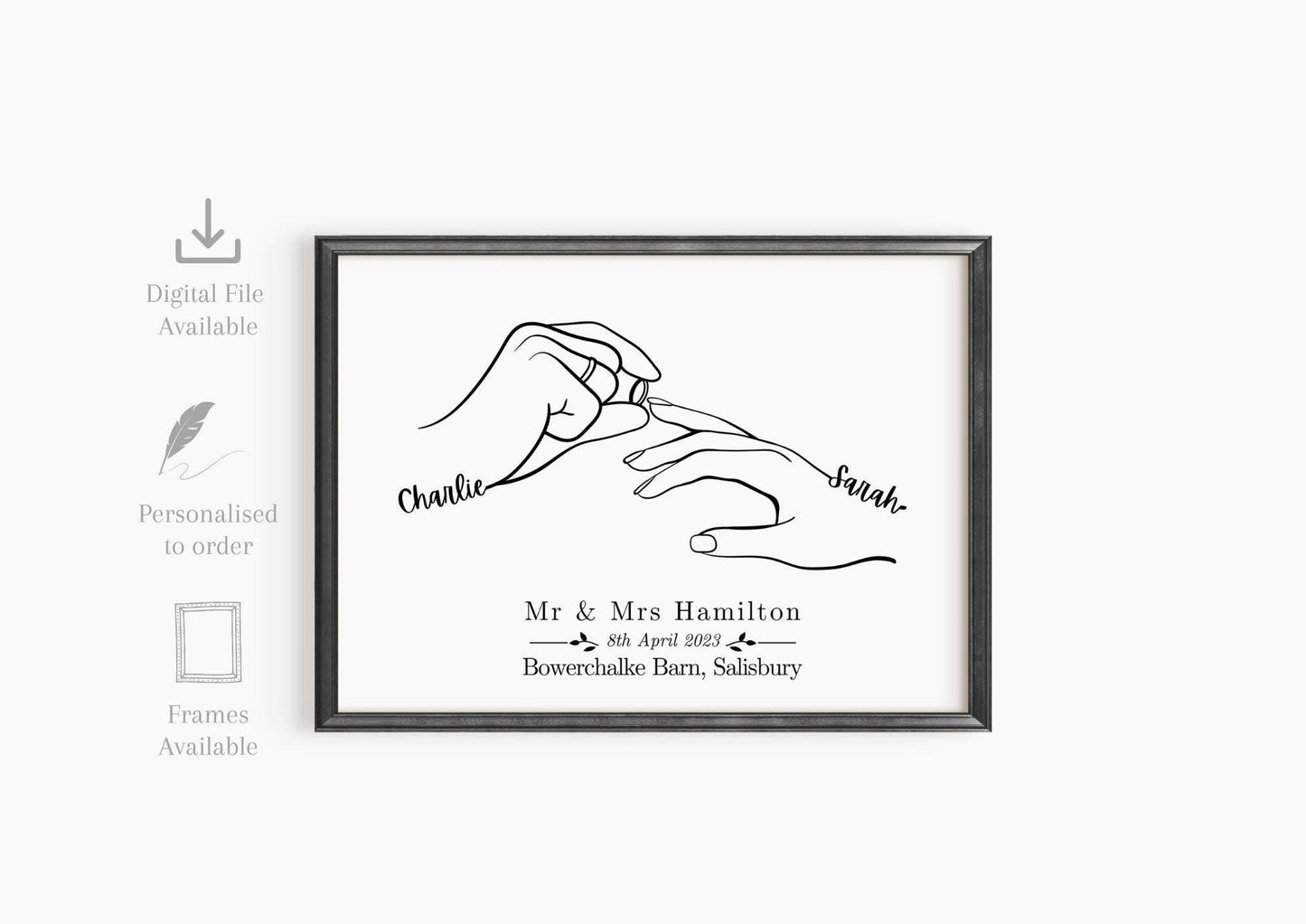 Framed custom wedding print featuring minimalist line art of two hands, with one person placing a wedding ring on the other. The hands are labeled with the names.
