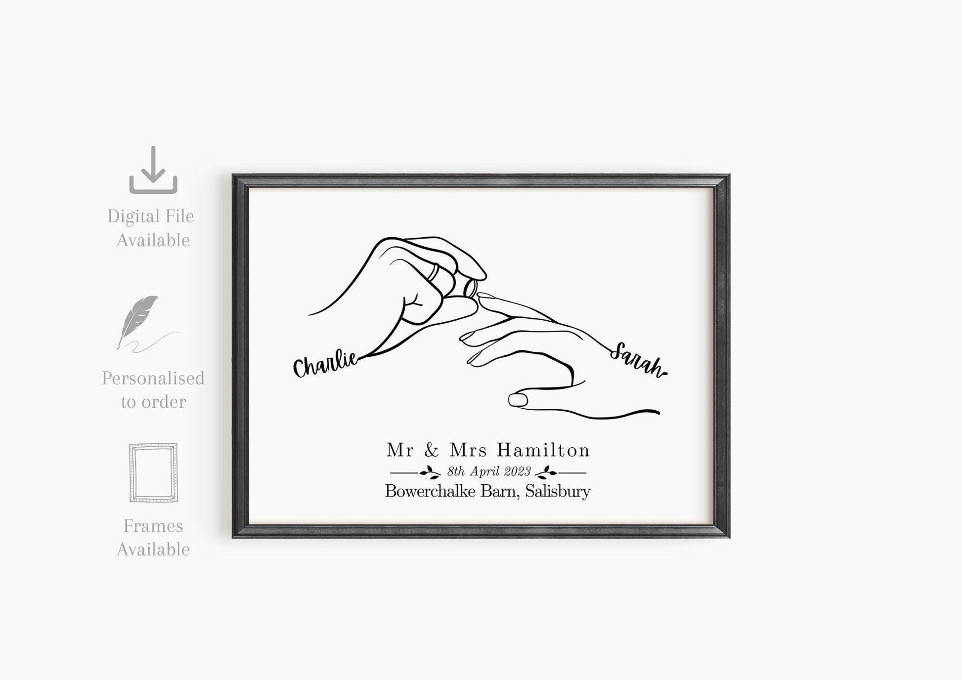 Framed custom wedding print featuring minimalist line art of two hands, with one person placing a wedding ring on the other. The hands are labeled with the names.