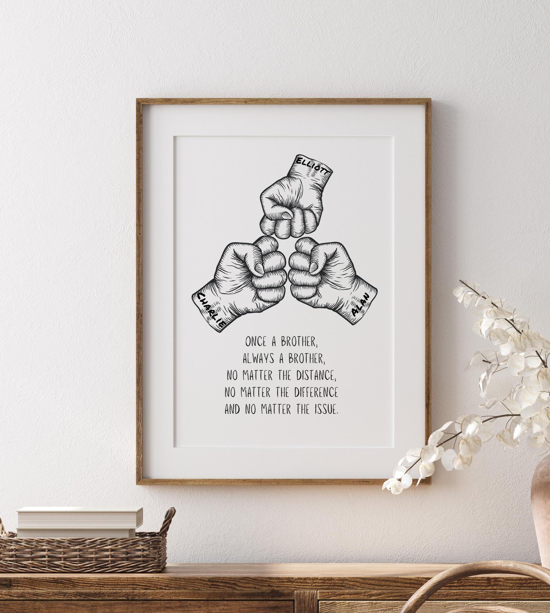 Framed wall art featuring a hand-drawn illustration of three fists in a fist bump gesture, accompanied by an inspirational quote about brotherhood. Perfect as a gift or home décor for celebrating sibling bonds